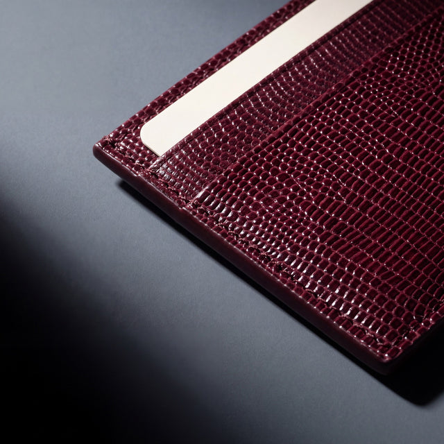 Close-up of the grain and edge of a burgundy lizard-embossed leather card holder by GENTCREATE