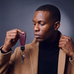 Man heading out with house keys on a burgundy lizard-embossed leather keychain by GENTCREATE