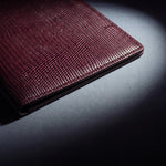 Close-up of the leather grain of a burgundy lizard-embossed leather passport holder by GENTCREATE