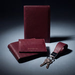 Matching burgundy lizard-embossed leather passport holder, wallet, card holder and keychain by GENTCREATE