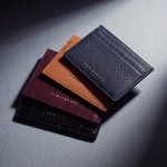 Card holders by GENTCREATE in crocodile-embossed, lizard-embossed, Saffiano and pebble leather, stacked