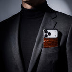 Brown crocodile-embossed iPhone 18 Pro case by GENTCREATE in the breast pocket of a charcoal suit jacket