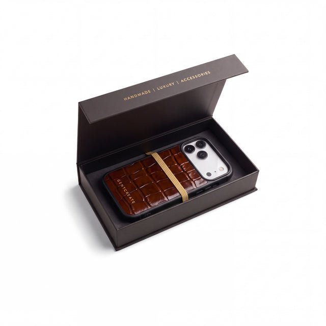 Brown crocodile-embossed iPhone 18 Pro case by GENTCREATE in its black gift box with a gold band