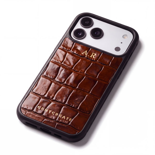 Brown crocodile-embossed iPhone 18 Pro case by GENTCREATE with the initials A.R hot-stamped in gold