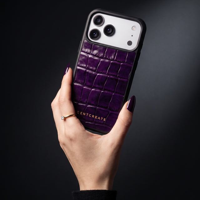 Hand with aubergine nails holding a magenta glossy crocodile-embossed calfskin iPhone 18 Pro Max case by GENTCREATE