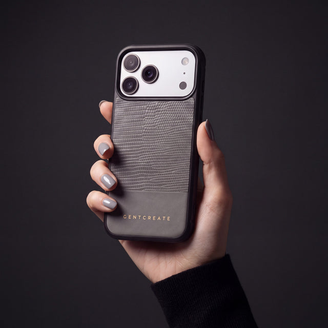 Hand with dove-gray nails holding a gray lizard-embossed calfskin iPhone 18 Pro Max case by GENTCREATE