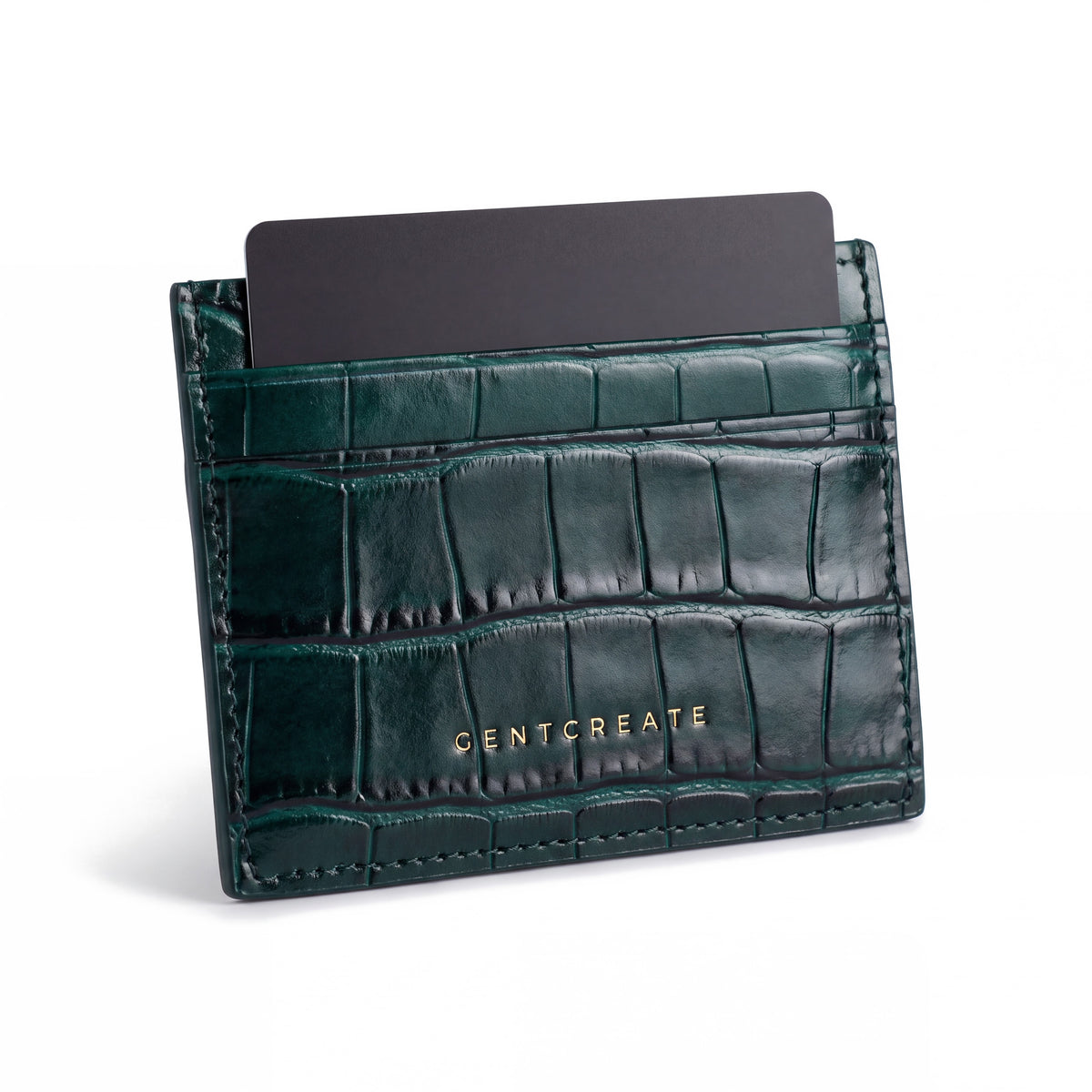 Green crocodile-embossed leather card holder by GENTCREATE standing with a card, on white