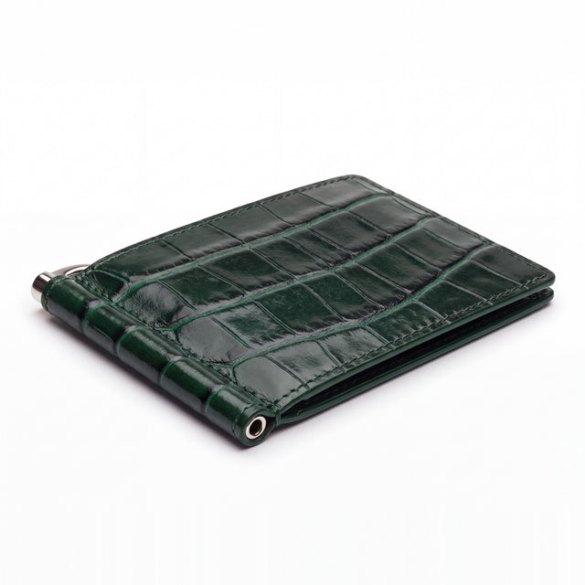 Closed green glossy crocodile-embossed leather money clip wallet by GENTCREATE with its silver clip, on white