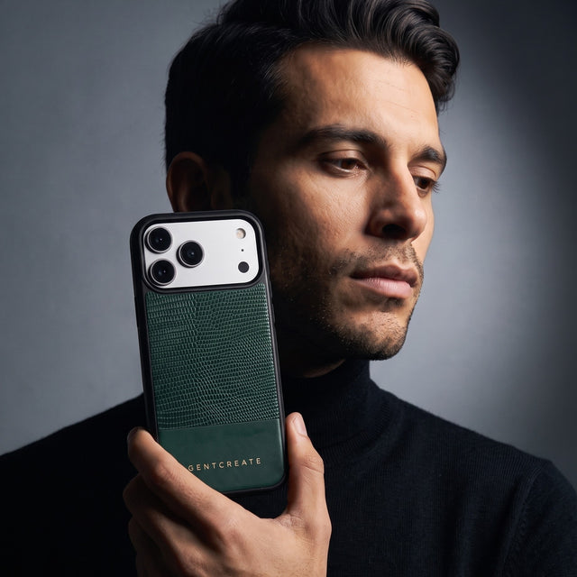 Man holding a green lizard-embossed leather iPhone 18 Pro Max case by GENTCREATE beside his face