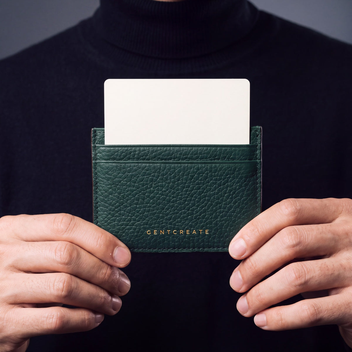 Close-up of hands holding a green pebble leather card holder by GENTCREATE with a card in the top slot
