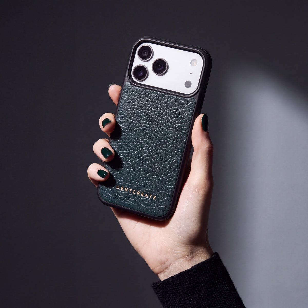 Hand with green nails holding a green pebble-grain calfskin iPhone 18 Pro Max case by GENTCREATE
