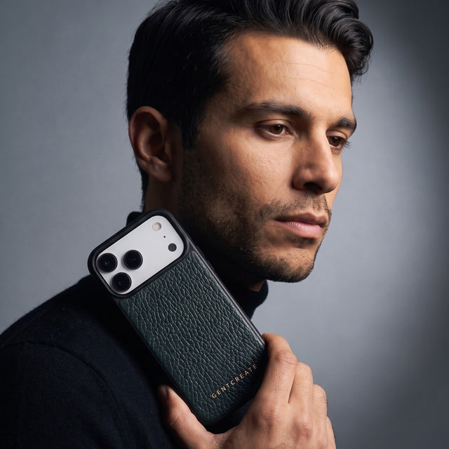 Man holding a green pebble-grain leather iPhone 18 Pro Max case by GENTCREATE beside his face