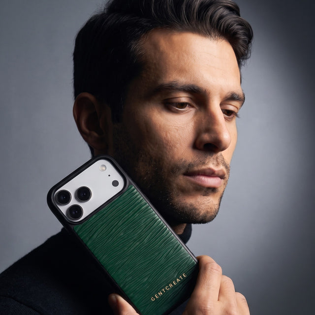 Man holding a green wave-embossed leather iPhone 18 Pro Max case by GENTCREATE beside his face