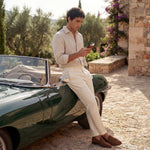 Old money pebble leather iPhone 17 Ori max case man holding the leather case leaning on a car.