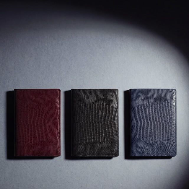 Lizard-embossed leather passport holder by GENTCREATE in burgundy, black and navy, laid flat