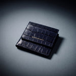 Navy crocodile-embossed card holder resting on a navy crocodile-embossed bifold wallet by GENTCREATE