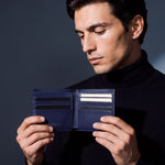 Man opening a navy crocodile-embossed leather bifold wallet by GENTCREATE to show the card slots