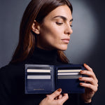 Woman opening a navy crocodile-embossed leather bifold wallet by GENTCREATE to show the card slots