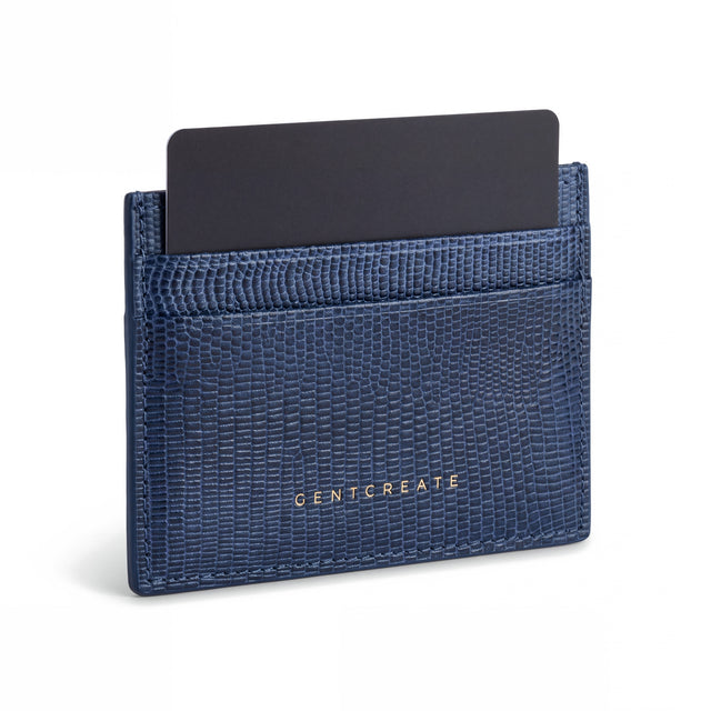 Navy lizard-embossed leather card holder by GENTCREATE standing with a card, on white