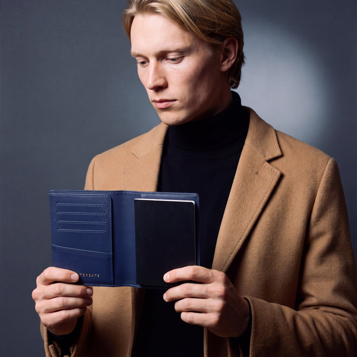 Man opening a navy lizard-embossed leather passport holder by GENTCREATE with a passport inside