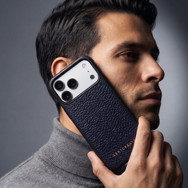 Man holding a navy pebble-grain leather iPhone 18 Pro Max case by GENTCREATE against his jaw