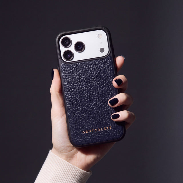 Hand with navy nails holding a navy pebble-grain calfskin iPhone 18 Pro Max case by GENTCREATE