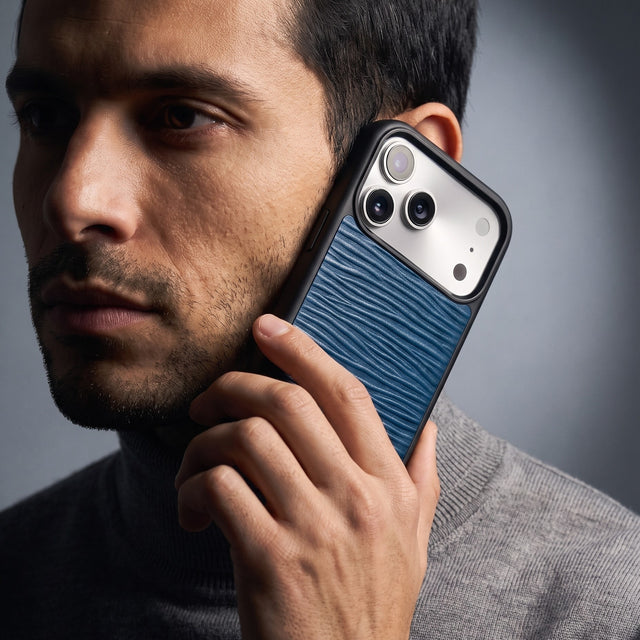 Man holding a navy wave-embossed leather iPhone 18 Pro Max case by GENTCREATE against his jaw