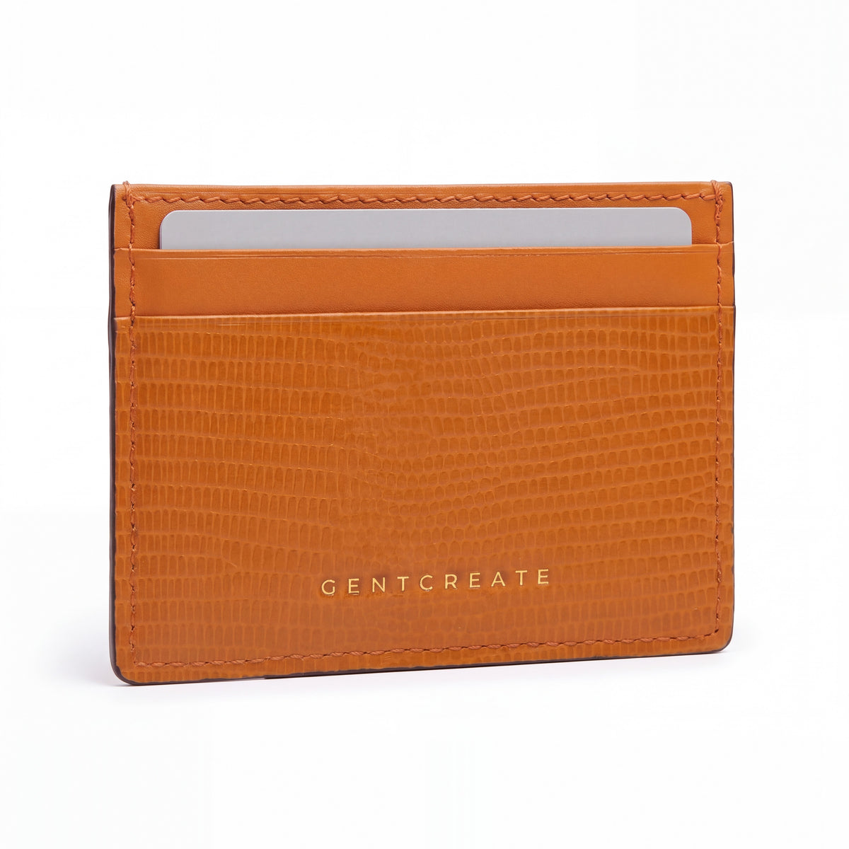 Orange lizard-embossed leather business card holder by GENTCREATE standing on white