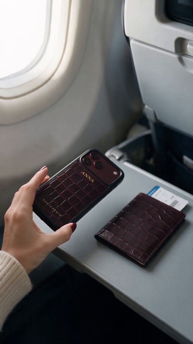 A burgundy croco case on a flight