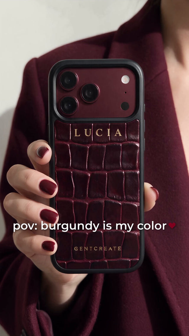 A burgundy croco case with a matching keychain and card holder