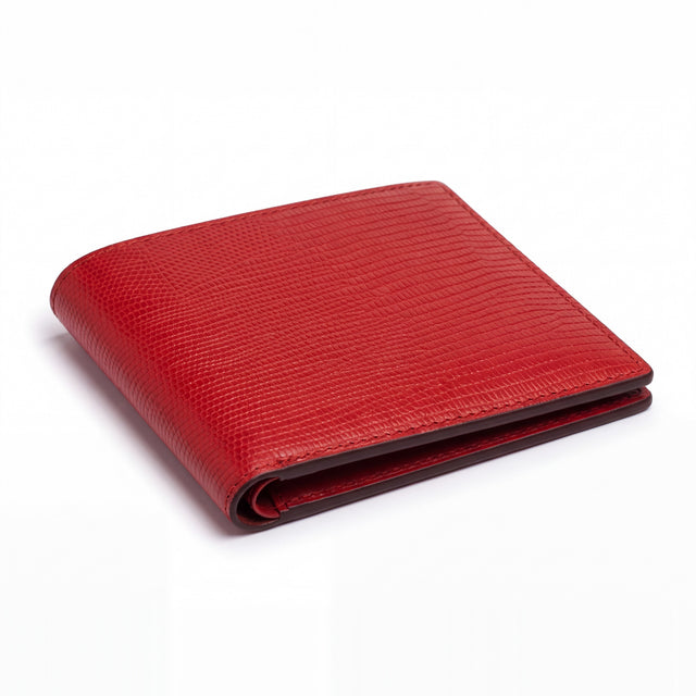 Closed red lizard-embossed leather bifold wallet by GENTCREATE lying on white