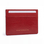 Red lizard-embossed leather business card holder by GENTCREATE standing on white