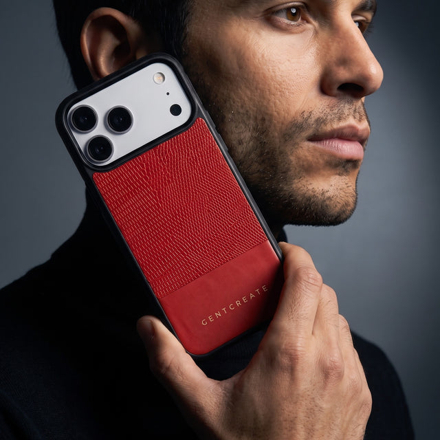 Man holding a red lizard-embossed leather iPhone 18 Pro Max case by GENTCREATE against his jaw