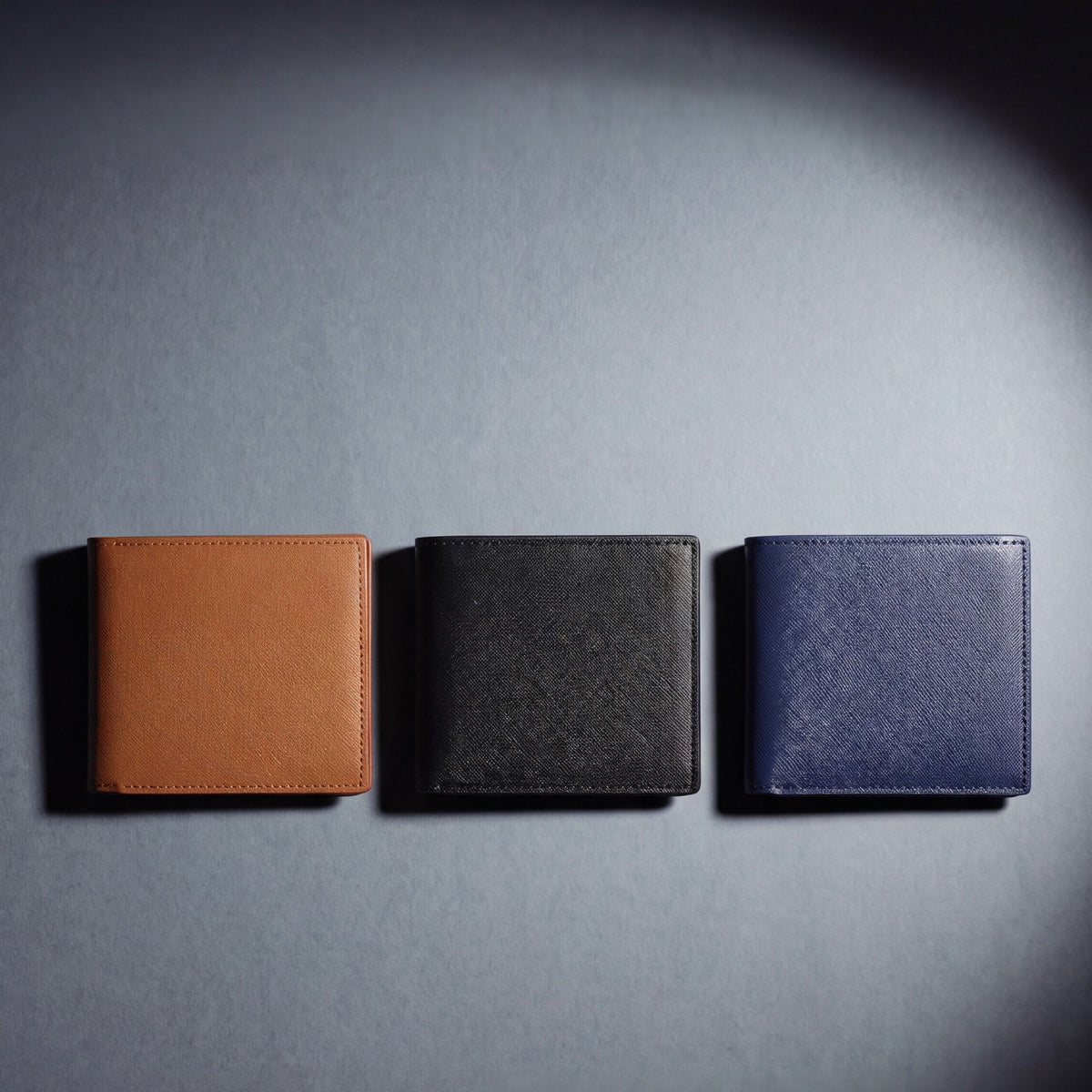 Saffiano leather bifold wallet by GENTCREATE in brown, black and navy, laid flat