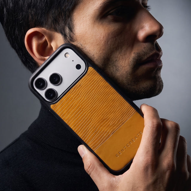 Man holding a yellow lizard-embossed leather iPhone 18 Pro Max case by GENTCREATE against his jaw