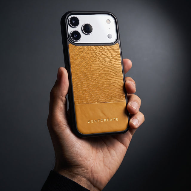 Hand holding a yellow lizard-embossed leather iPhone 18 Pro Max case by GENTCREATE in a single studio light