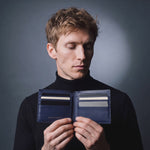 Man opening a navy Saffiano leather bifold wallet by GENTCREATE to show the card slots, video