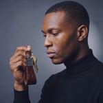 Man holding up a burgundy crocodile-embossed leather keychain by GENTCREATE with house keys, video