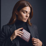 Woman sliding a burgundy crocodile-embossed leather bifold wallet by GENTCREATE into a blazer pocket, video