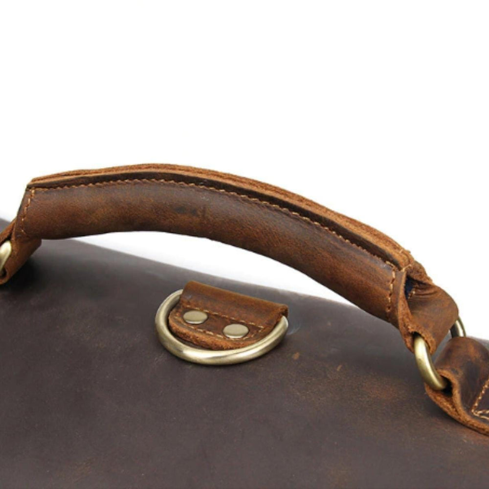 Handle of a luxury fashion messenger bag by a luxury fashion brand.