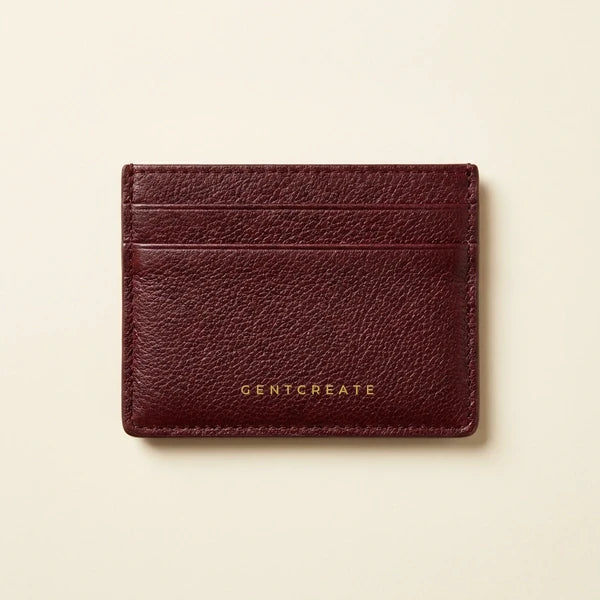Porta-cartões fino em pele granulada bordeaux com um pequeno logótipo GENTCREATE a dourado, o modelo mais produzido para encomendas corporativas