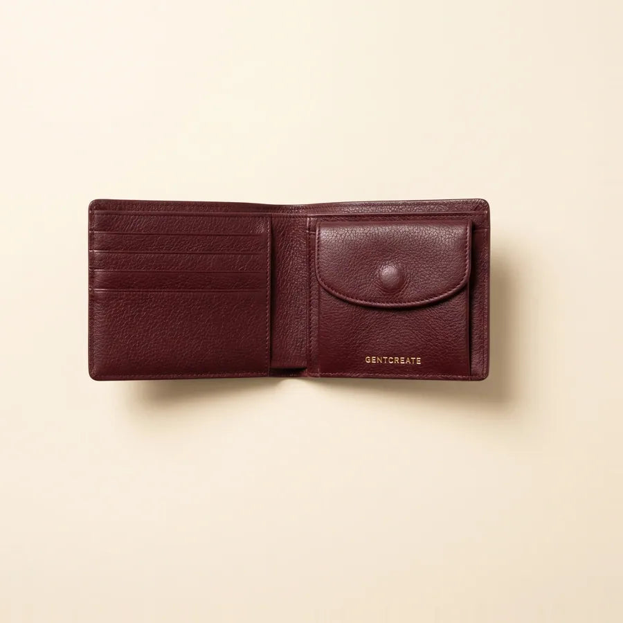 Carteira bifold em pele aberta para mostrar um porta-moedas com mola junto às ranhuras para cartões